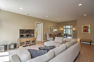 a living room with a large couch and a tv at Roomy Home with Deck, 5 Mi to Lake Arrowhead Village in Lake Arrowhead