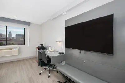 a room with a large flat screen tv on a wall at Aiden Los Angeles Downtown Dragon Gate Inn in Los Angeles