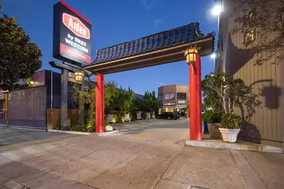a gas station with red columns in a parking lot at Aiden Los Angeles Downtown Dragon Gate Inn in Los Angeles