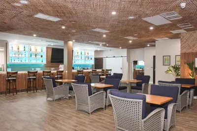 a restaurant with tables and chairs and a bar at Aiden Los Angeles Downtown Dragon Gate Inn in Los Angeles