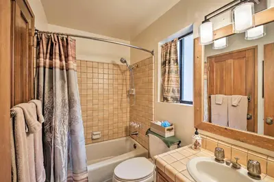 a bathroom with a sink and a toilet and a tub at Spacious Lake Arrowhead Home with 2 Decks and Views in Lake Arrowhead