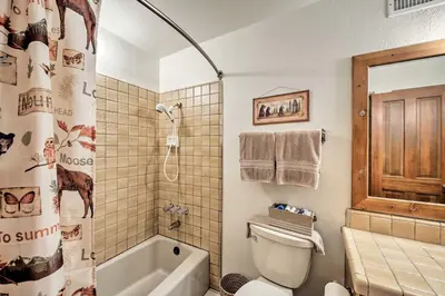a bathroom with a toilet and a tub and a shower at Spacious Lake Arrowhead Home with 2 Decks and Views in Lake Arrowhead