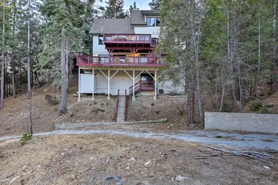 a house on a hill in the woods at Spacious Lake Arrowhead Home with 2 Decks and Views in Lake Arrowhead