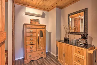a bathroom with a wooden dresser and a mirror at Remodeled Crestline Retreat Walk to Lake Gregory! in Crestline