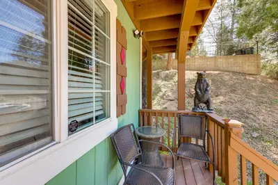 a porch with two chairs and a bear statue on it at Remodeled Crestline Retreat Walk to Lake Gregory! in Crestline