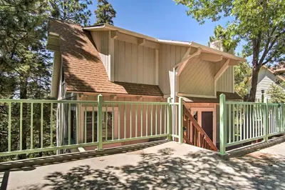 a house with a porch with a green fence at 5 Mi to Lake Arrowhead Village Cabin with Game Room in Lake Arrowhead