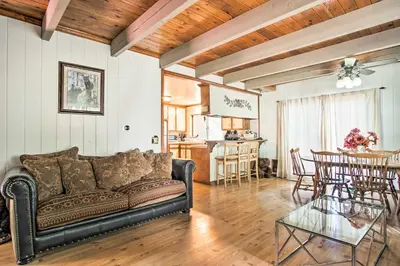 a living room with a couch and a table at 5 Mi to Lake Arrowhead Village Cabin with Game Room in Lake Arrowhead