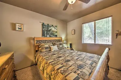 a bedroom with a bed and a window at Family Cabin with Game Room Near Hiking and Skiing! in Lake Arrowhead