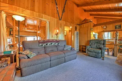 a living room with a couch and a chair at Big Bear Lake Cabin with Deck about 7 Mi to Ski Slopes! in Fawnskin