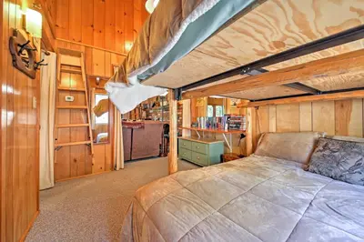 a bedroom with a bed in a tiny house at Big Bear Lake Cabin with Deck about 7 Mi to Ski Slopes! in Fawnskin