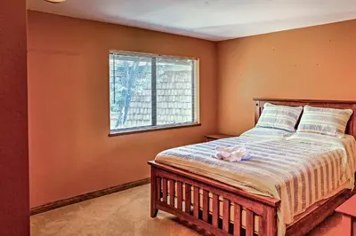 a bedroom with a bed with a pink bow on it at Lake Arrowhead House with Lake Views and Wet Bar! in Lake Arrowhead