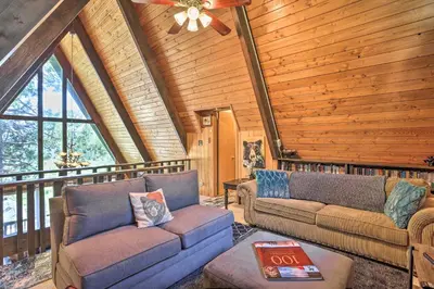 a living room with two couches and a ceiling fan at A-Frame Home with 3 Decks and Lake Arrowhead Views! in Lake Arrowhead