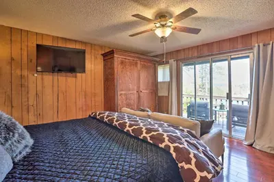 a bedroom with a giraffe bed with a ceiling fan at A-Frame Home with 3 Decks and Lake Arrowhead Views! in Lake Arrowhead