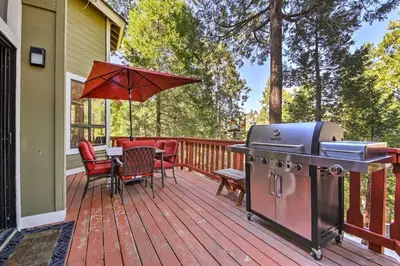 a grill on a deck with a table and chairs at Lake Arrowhead Family Home with Deck! in Lake Arrowhead