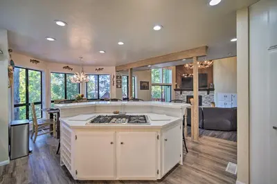 a kitchen with a stove top island in a room at Lake Arrowhead Family Home with Deck! in Lake Arrowhead