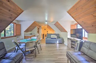a living room with a table and a couch at Lake Arrowhead Family Home with Deck! in Lake Arrowhead