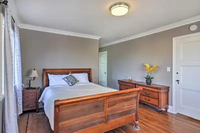 a bedroom with a wooden bed and a wooden dresser at The Castle Hacienda Heights Home with Patio and Pool in Hacienda Heights