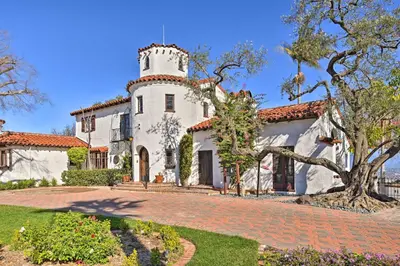 a large white house with a tower on top at The Castle Hacienda Heights Home with Patio and Pool in Hacienda Heights