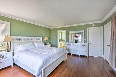a bedroom with a white bed and green walls at The Castle Hacienda Heights Home with Patio and Pool in Hacienda Heights