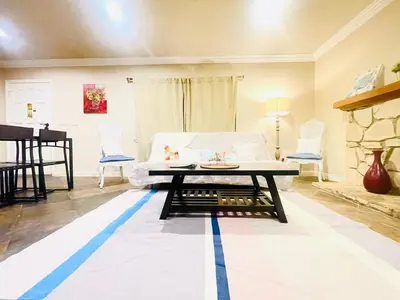 a living room with a white couch and a table at GREAT FOR BUSINESS & FAMILY TRIPS 3BD 2BA close to DESNEYLAND, FREE PARKING in Orange