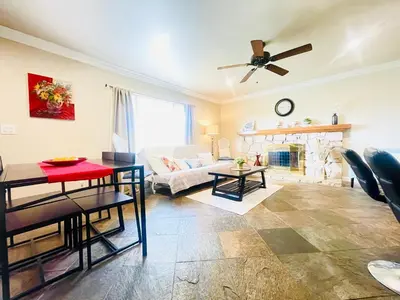 a living room with a table and a couch at GREAT FOR BUSINESS & FAMILY TRIPS 3BD 2BA close to DESNEYLAND, FREE PARKING in Orange