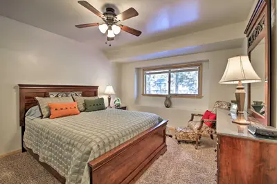 a bedroom with a bed and a ceiling fan at Walk to Lake Rustic Home with Deck in Fawnskin in Fawnskin