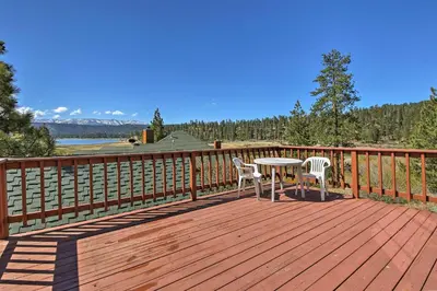 a wooden deck with a table and two chairs on it at Walk to Lake Cabin with Deck and Views in Fawnskin in Fawnskin