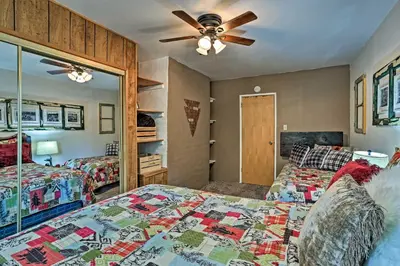 a bedroom with two beds and a ceiling fan at Expansive Retreat with Deck, Game Room and Lake Views! in Lake Arrowhead