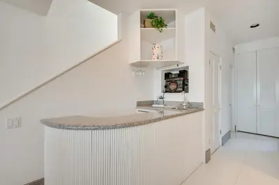 a white kitchen with a counter top in a house at Beachfront Malibu House with Sauna and Ocean-View Deck in Malibu
