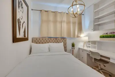 a bedroom with a large bed and a desk at Beachfront Malibu House with Sauna and Ocean-View Deck in Malibu