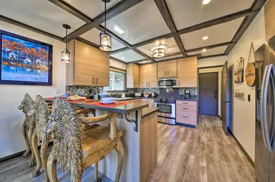 a kitchen with a large island with a wooden counter top at Bikes and Game Room Lovely Lake Arrowhead Home! in Lake Arrowhead