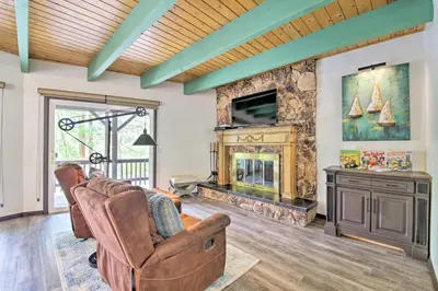 a living room with a couch and a fireplace at Bikes and Game Room Lovely Lake Arrowhead Home! in Lake Arrowhead
