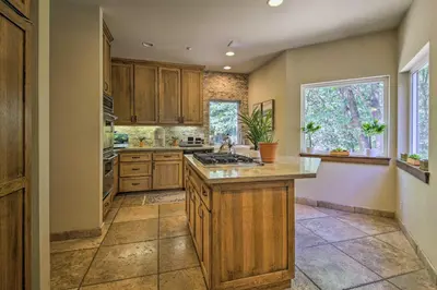 a kitchen with wooden cabinets and a counter top at Incredible Lake Arrowhead Home with Views and Decks! in Lake Arrowhead