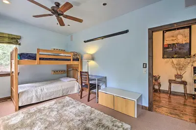 a bedroom with a bunk bed and a desk at Incredible Lake Arrowhead Home with Views and Decks! in Lake Arrowhead