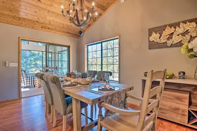 a dining room with a wooden table and chairs at Spacious Pine Mtn Club Cabin with Game Room and Deck in Pine Mountain Club