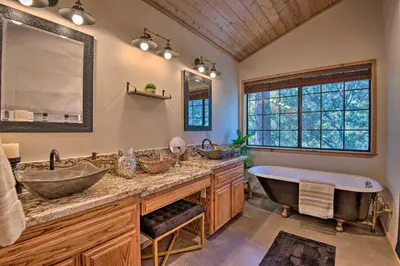 a bathroom with two sinks and a bath tub at Spacious Pine Mtn Club Cabin with Game Room and Deck in Pine Mountain Club