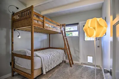 a bunk bed in a small room with a ladder at Remodeled Ventura Beach Home with Yard and Fire Pit! in Ventura