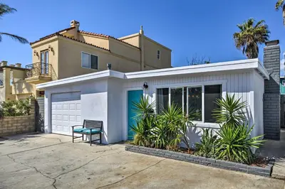 a white house with a bench in front of it at Remodeled Ventura Beach Home with Yard and Fire Pit! in Ventura