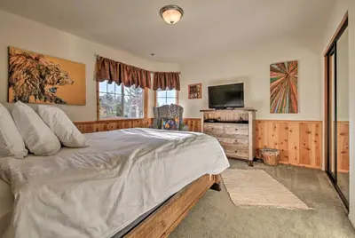 a bedroom with a bed and a flat screen tv at Hot Tub, Game Room and 2 Decks Luxe Big Bear Home in Big Bear Lake