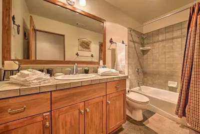 a bathroom with a sink and a toilet and a mirror at Hot Tub, Game Room and 2 Decks Luxe Big Bear Home in Big Bear Lake