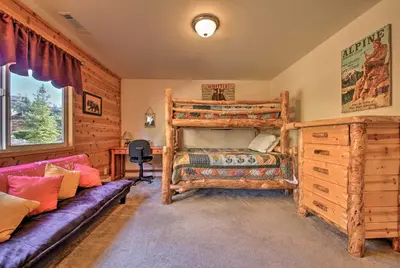 a bedroom with a bunk bed and a couch at Hot Tub, Game Room and 2 Decks Luxe Big Bear Home in Big Bear Lake