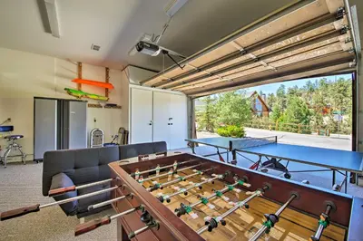 a living room with a ping pong table at Hot Tub, Game Room and 2 Decks Luxe Big Bear Home in Big Bear Lake