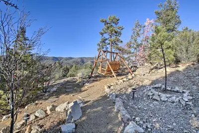 a playground on the side of a hill with trees at Hot Tub, Game Room and 2 Decks Luxe Big Bear Home in Big Bear Lake