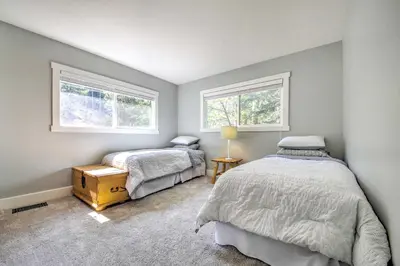 a bedroom with two beds and two windows at Gorgeous Lake Arrowhead Retreat Game Room and Deck in Lake Arrowhead