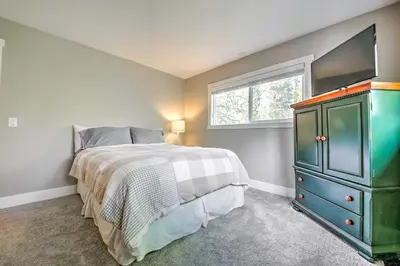 a bedroom with a bed and a dresser and a window at Gorgeous Lake Arrowhead Retreat Game Room and Deck in Lake Arrowhead