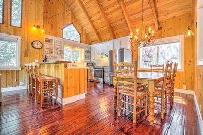 a kitchen and dining room with a table and chairs at Gorgeous Lake Arrowhead Retreat Game Room and Deck in Lake Arrowhead