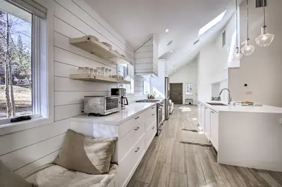 a kitchen with white cabinets and a sink at Half-Mi to Big Bear Lake Modern Home with Deck in Big Bear Lake