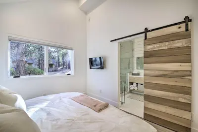 a bedroom with a bed and a sliding glass door at Half-Mi to Big Bear Lake Modern Home with Deck in Big Bear Lake