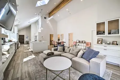 a living room with a couch and a table at Half-Mi to Big Bear Lake Modern Home with Deck in Big Bear Lake