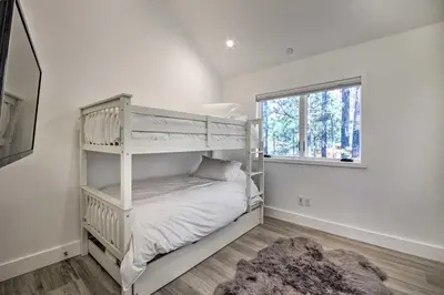 a white bunk bed in a room with a window at Half-Mi to Big Bear Lake Modern Home with Deck in Big Bear Lake